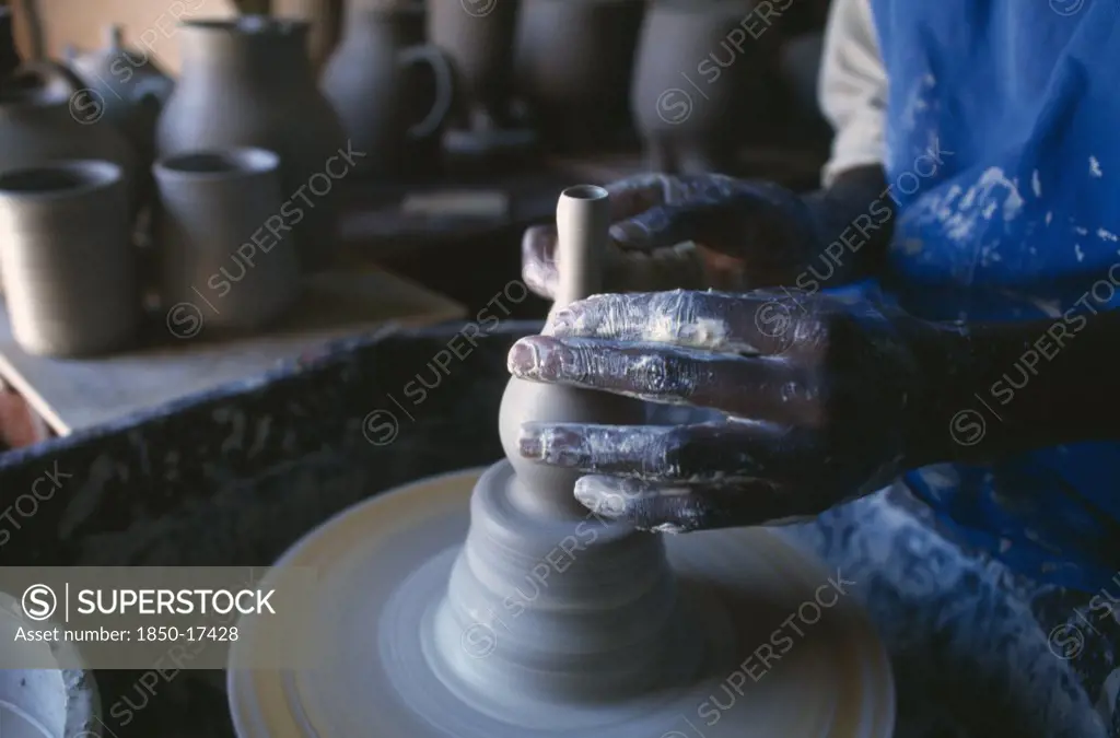 Malawi, Dedza, Dedza Potteries Producing Fair Trade Goods For Export.  Cropped View Of Potter Working At Wheel.