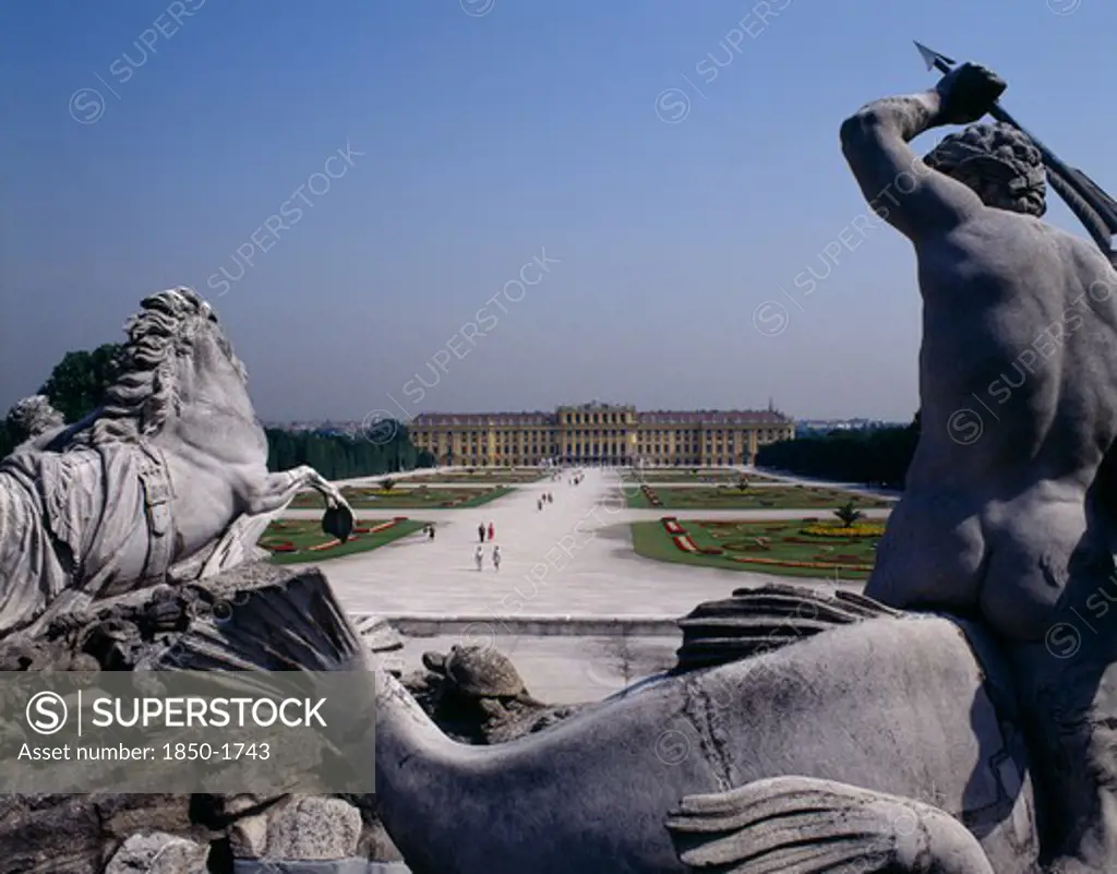 Austria, Vienna, Schonbrunn Palace Beyond Approach Path With Horse And Man Statue In Foreground