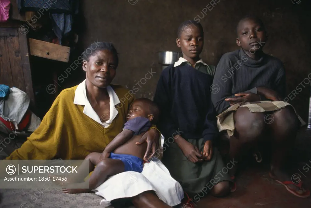 Kenya, Nairobi, 'Korogocho Slum Area.  Margaret With Two Of Her Children And Her Fourteen Year Old Servant Girl Eppy On The Right.  Like Many Girls, Eppy Works For Her Keep.'