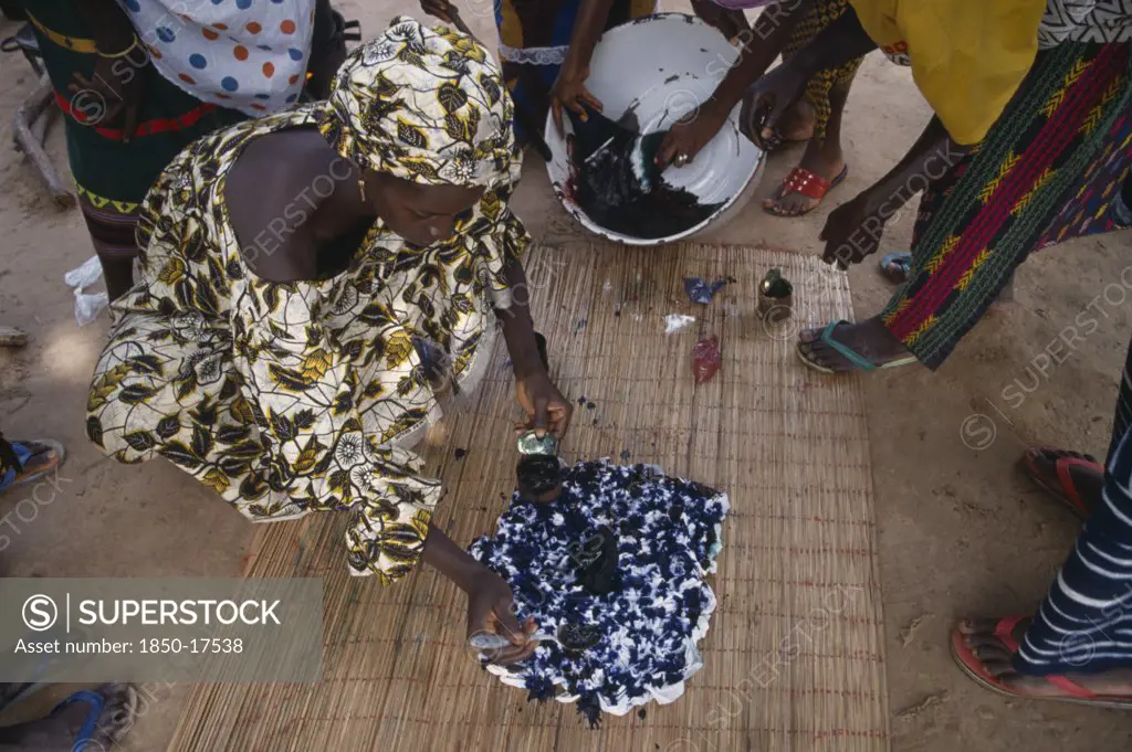 Gambia, Arts, Women Applying Indigo Dye To Cloth During Tie Dye Process.