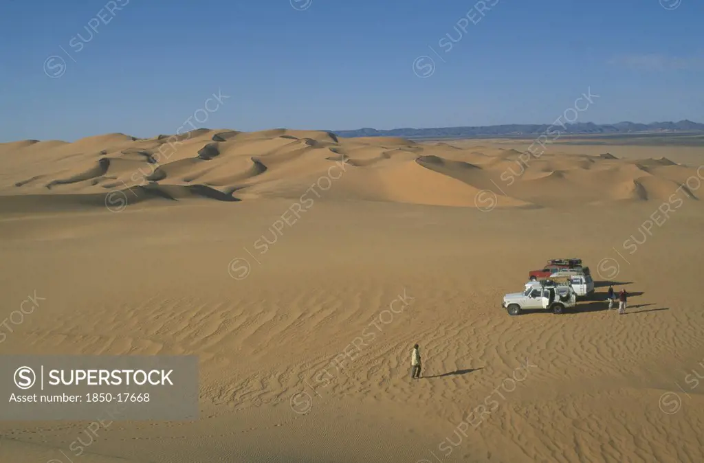 Libya, Sahara Desert, Tourists With Four By Four Vehicles In Desert Landscape.