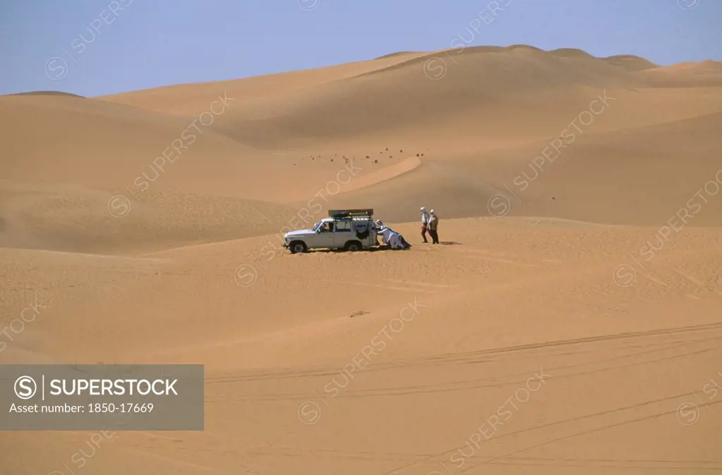 Libya, Sahara Desert, Tourists Four By Four Vehicle Stuck In Saharan Sand.