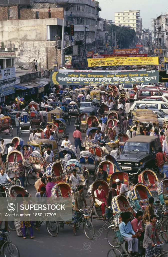 Bangladesh, Dhaka, Street Crowded With Brightly Painted And Decorated Rickshaws.