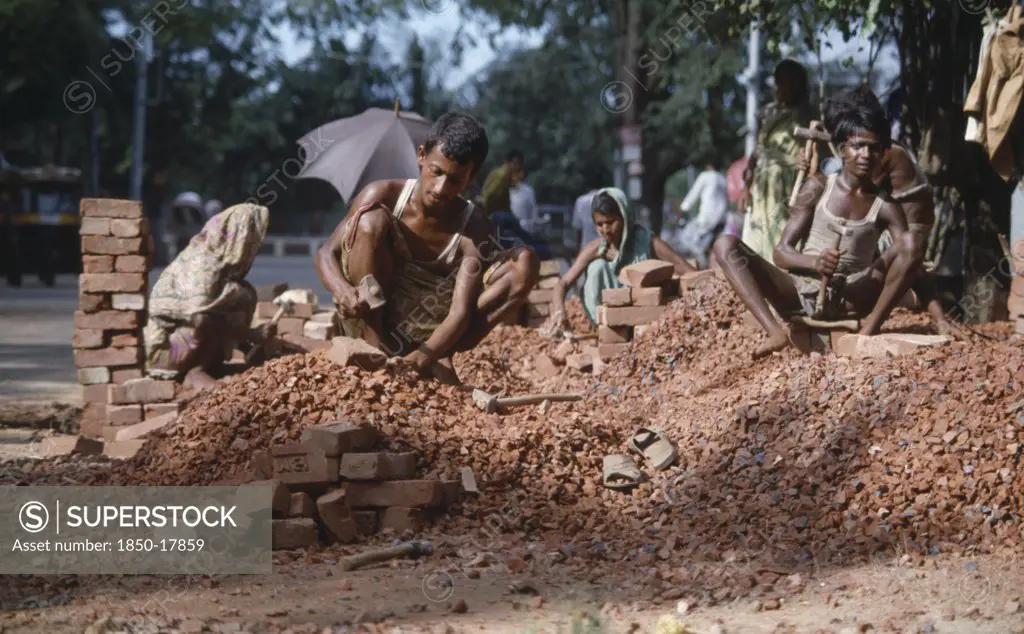Bangladesh, Dhaka, Men And Women Stone Breaking With Bricks And Hammers