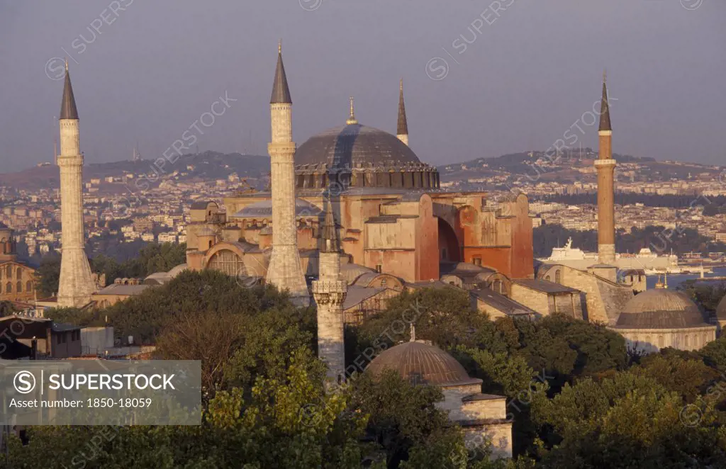 Turkey, Istanbul, Dome And Minarets Of Haghia Sophia Amongst Rooftops Of The Sultanahmet.  Former Mosque Now Museum.