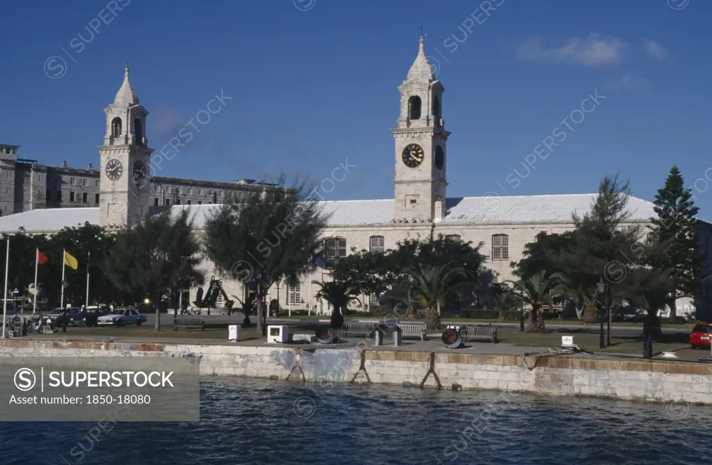 Bermuda, Sandys Parish, Clocktower Mall Formally The Offices Of The Royal Naval Dockyard Seen From Across Water With Trees Along The Banks