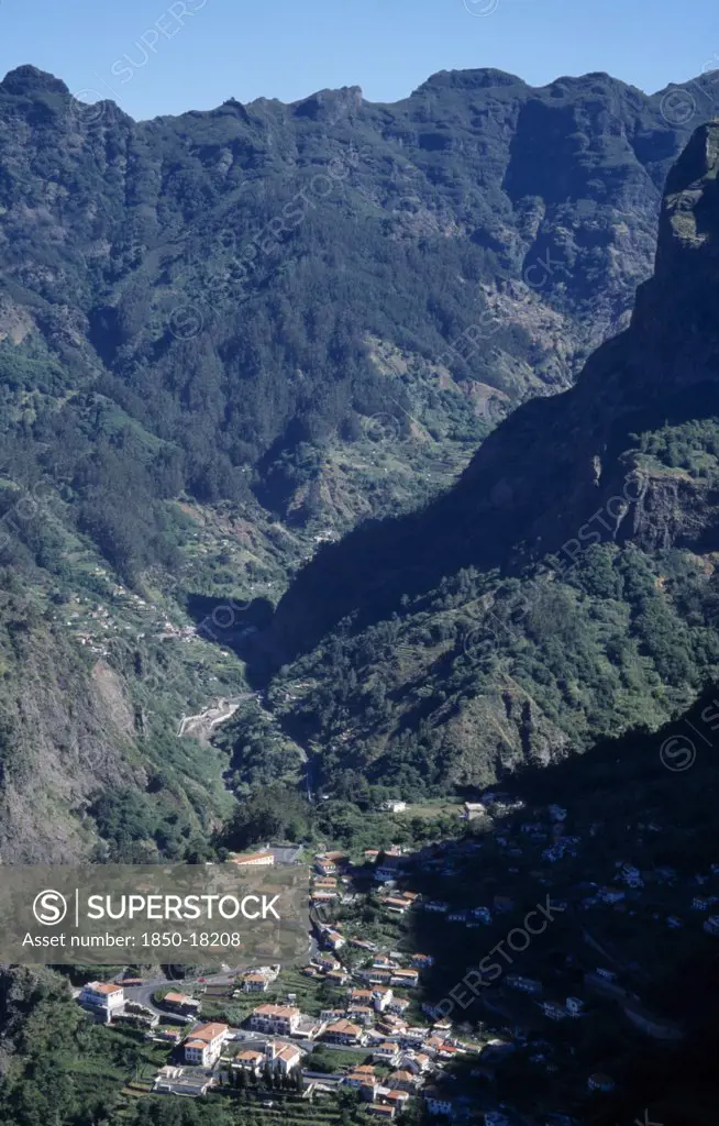 Portugal, Madeira, Camara De Lobos, Curral Das Freiras. View Over The Valley With Partially Forested Mountains Encircling The Village
