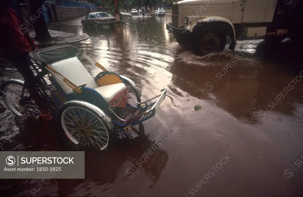 Cambodia, Phnom Penh, 'Street Near The Royal Hotel Flooded After The Monsoon Rains.  Car, Truck And Rickshaw Surrounded By Water.'