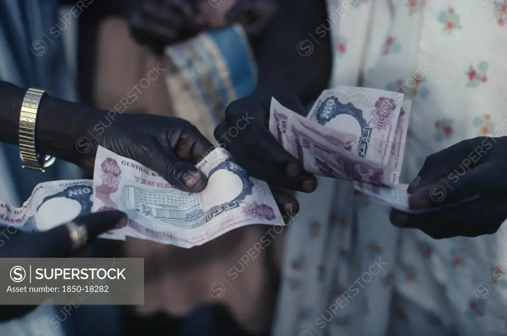 Nigeria, Money, Cropped Shot Of Money Changing Hands.