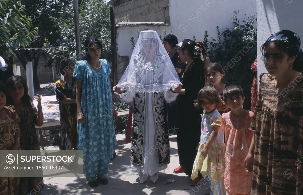 Tajikistan, Wedding, 'The Bride In A White Dress, Veil And Decorated Jacket Surrounded By Guests At A Village Wedding.'