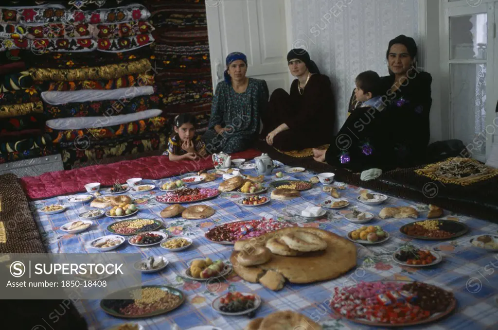 Tajikistan, Food, 'Three Women And Two Children Sit By A Large Display Of Food Laid Out, Awaiting The Guests From The Village Wedding.'
