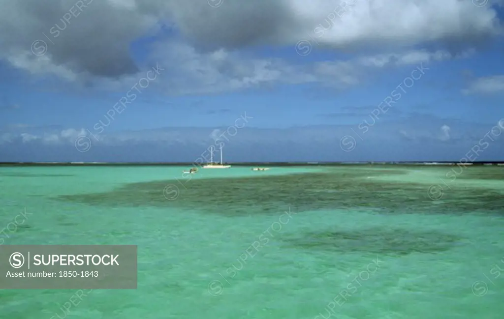 West Indies, Tobago, Buccoo Reef, The Nylon Pool With Yacht Anchored On The Horizon