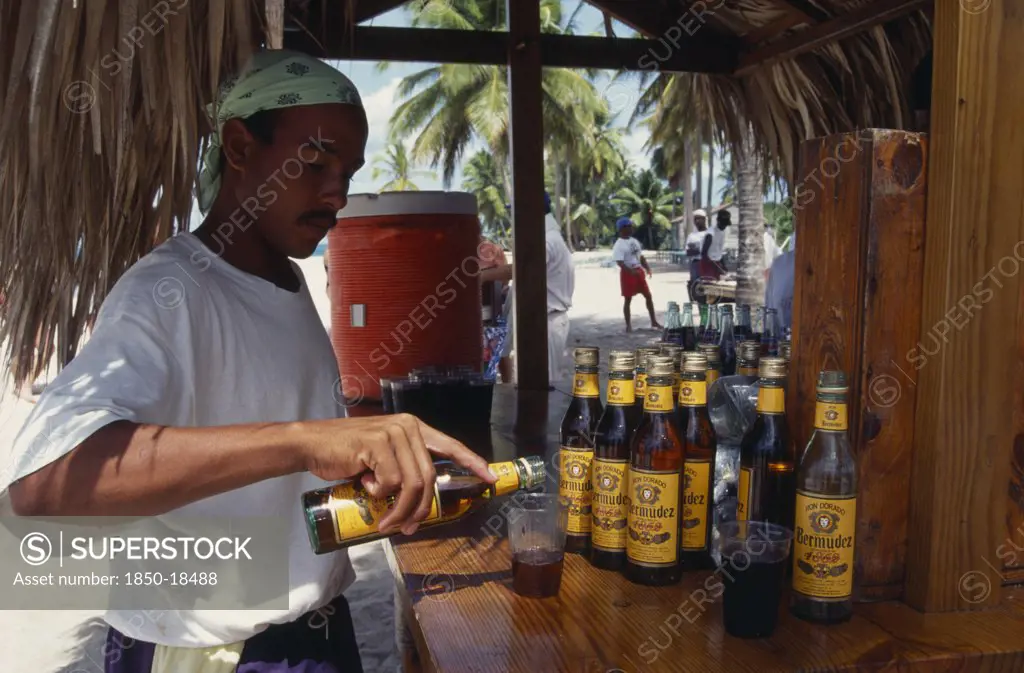 Dominican Republic, People, Men, Man Pouring Rum Into A Glass At A Tiki Style Bar