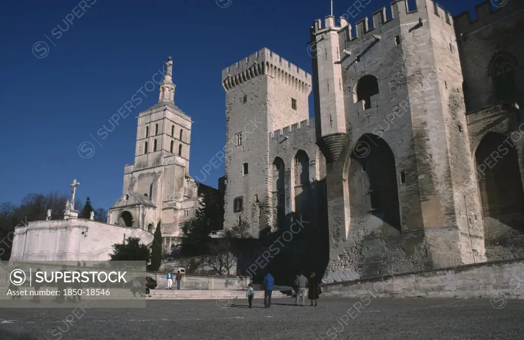 France, Provence Cote DAzur, Vaucluse, Avignon.  Palais Des Papes And Cathedral Notre Dame Des Doms With Visitors In Courtyard Below.