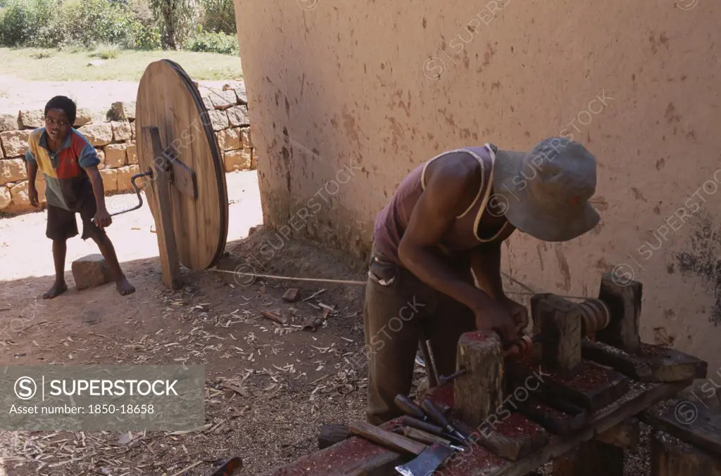 Madagascar, Ambositra,  Artisan Carving Rosewood Using Child Powered Lathe