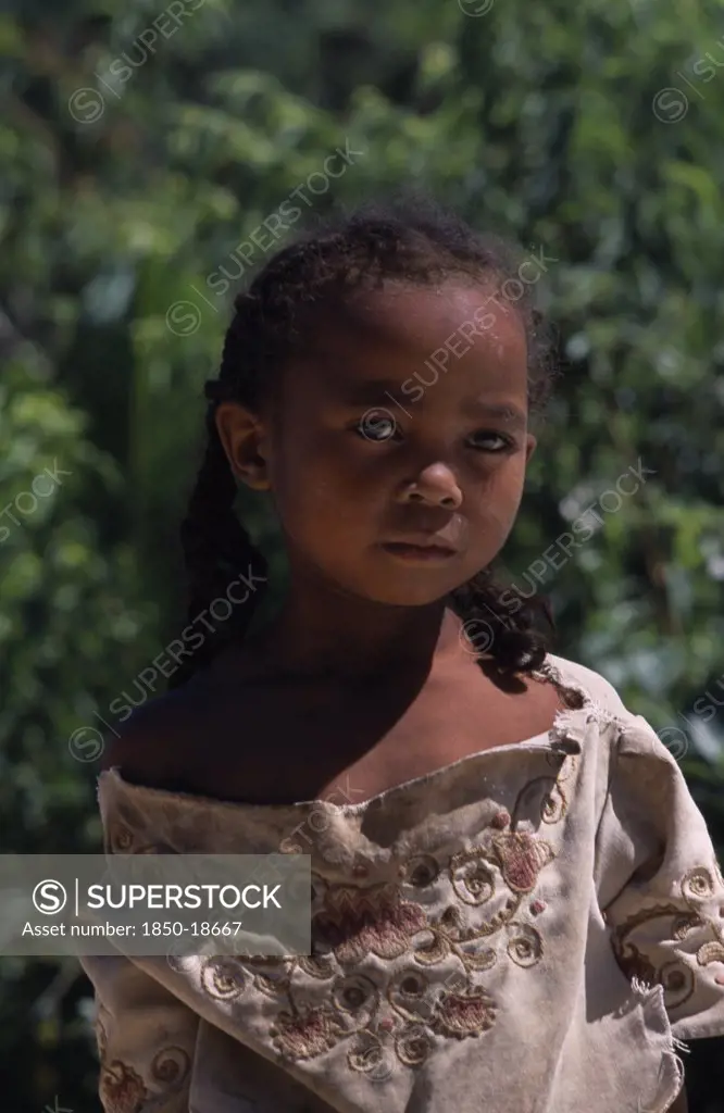 Madagascar, People, Children, Road To Ambalavao. Portrait Of A Young Girl Wearing Pig Tails In Her Hair