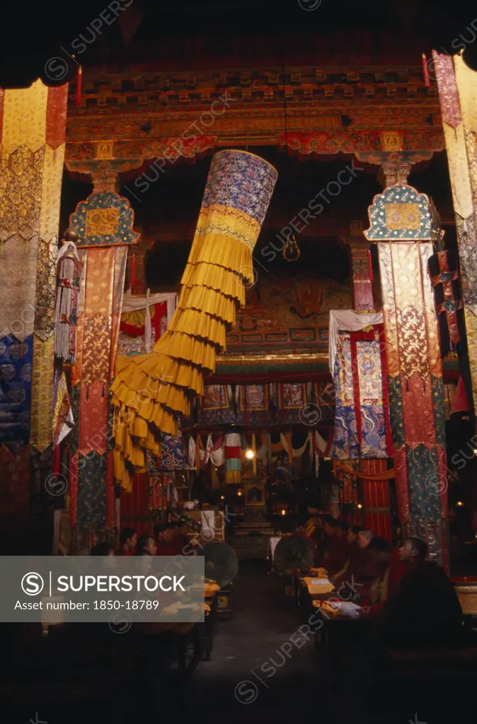 China, Tibet, Monks Chanting In The Main Chapel Of Gonggar Chode Monastery Near Lhasa Airport.