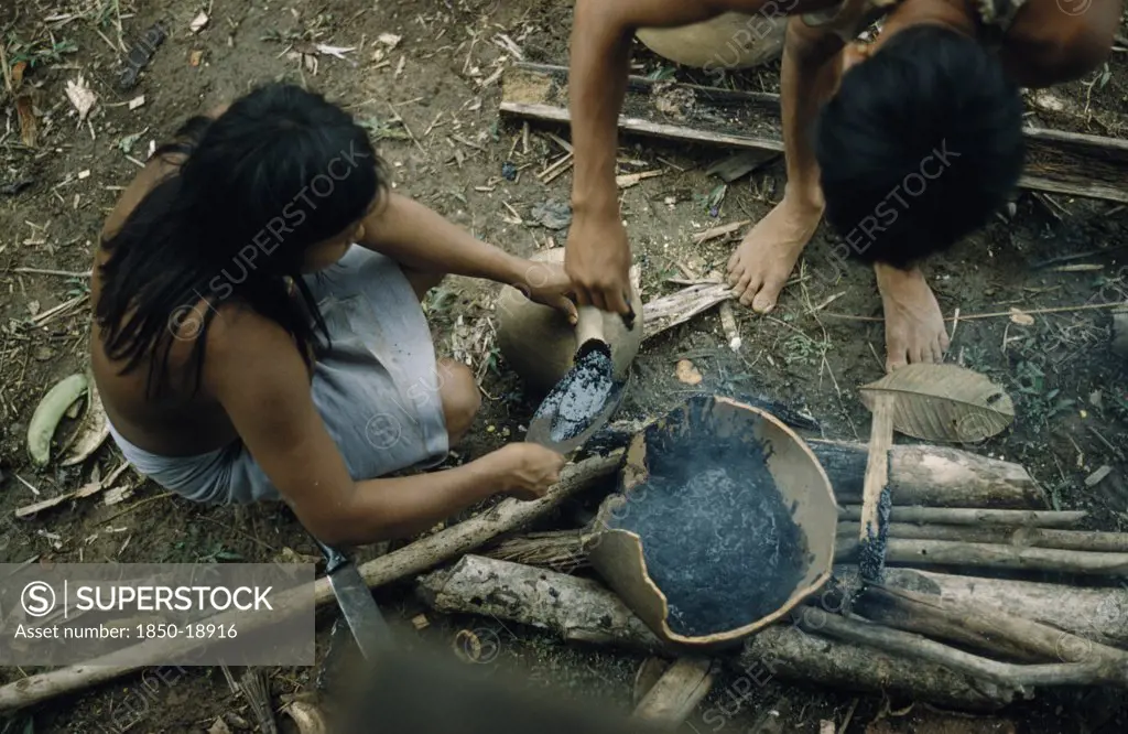 Colombia, Choco Region, Noanama Tribe, Woman Pouring Breo / Melted Beeswax Into A Fired Cantaro / Clay Water Pot Which Will Now Be Watertight