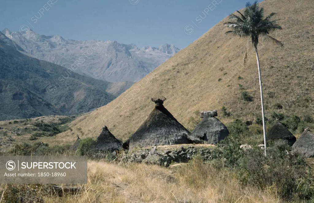 Colombia, Sierra Nevada De Santa Marta, Kogi Tribe, Religious Centre Of Takina Where Very Young Boys Are Trained To Become Mamas / Priests. Racks Of Sacred Potsherds At Apex Of Each Nuhue / Temple Roof. Lesser Peaks Of Sierra Nevada In Background