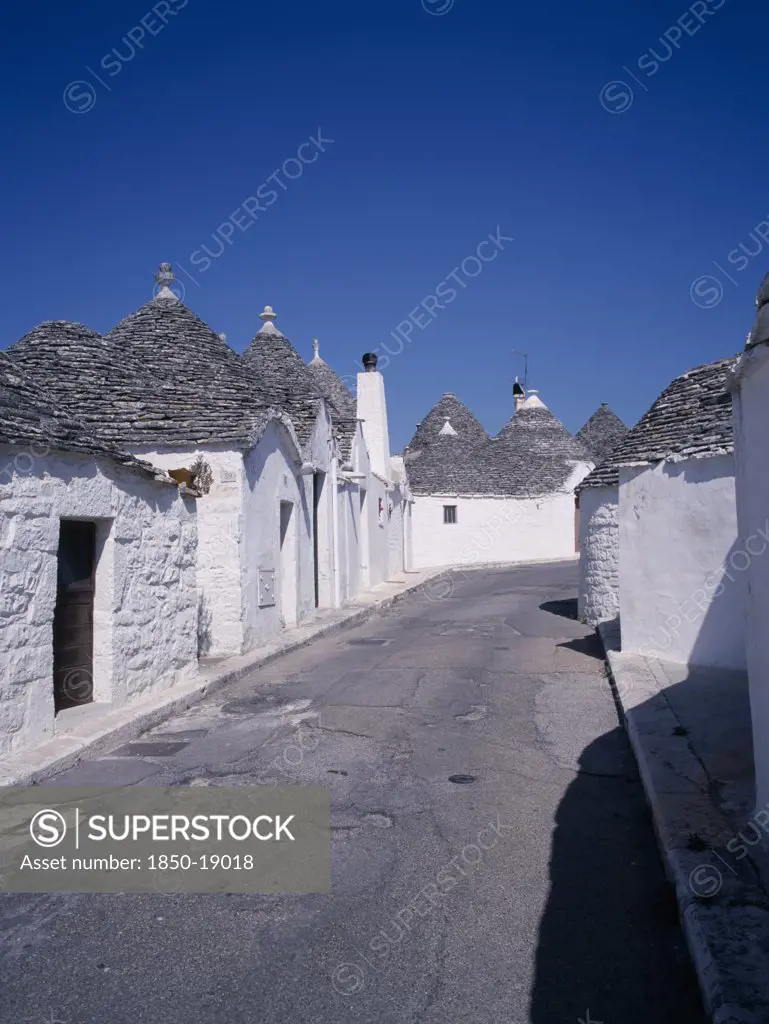 Italy, Puglia, Bari, 'White Trulli Buildings With Grey Stone Roofs In Alberobello Village That Have Been Converted Into Houses. No Mortar Is Used, Although The Interior Is Plastered.'