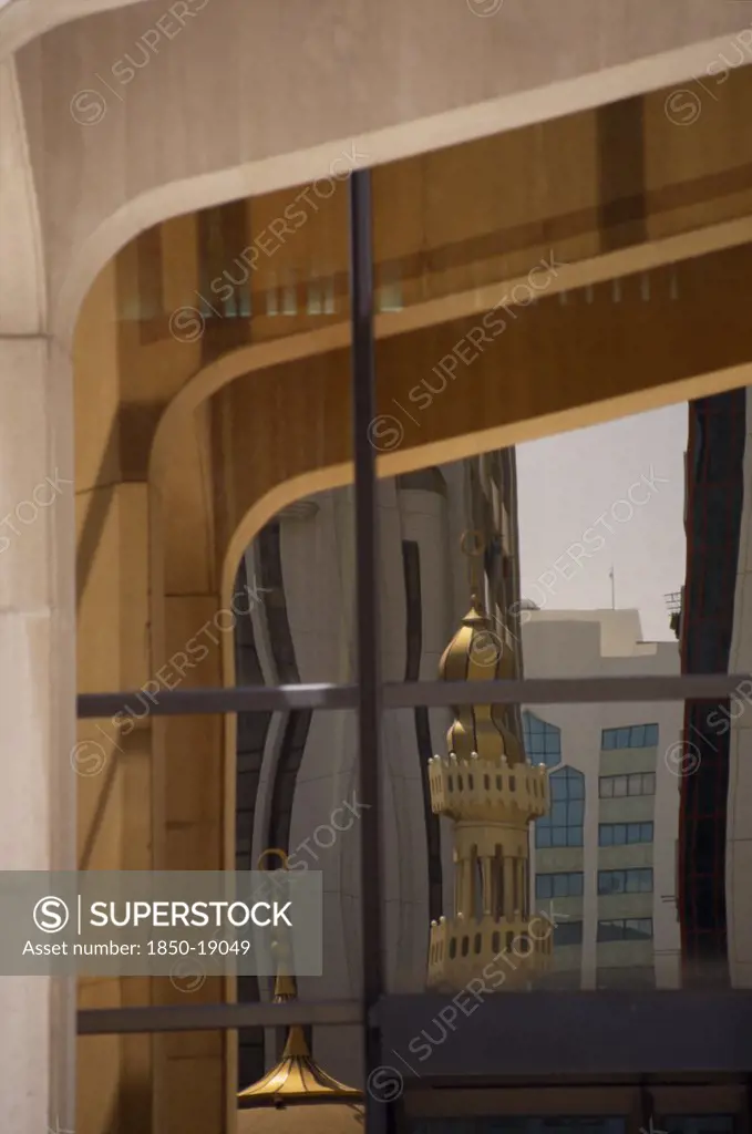Uae, Abu Dhabi, Arabian Monetary Fund Head Office Building. Detail Of  Windows With Minarets And Tall Buildings Reflected In The Glass
