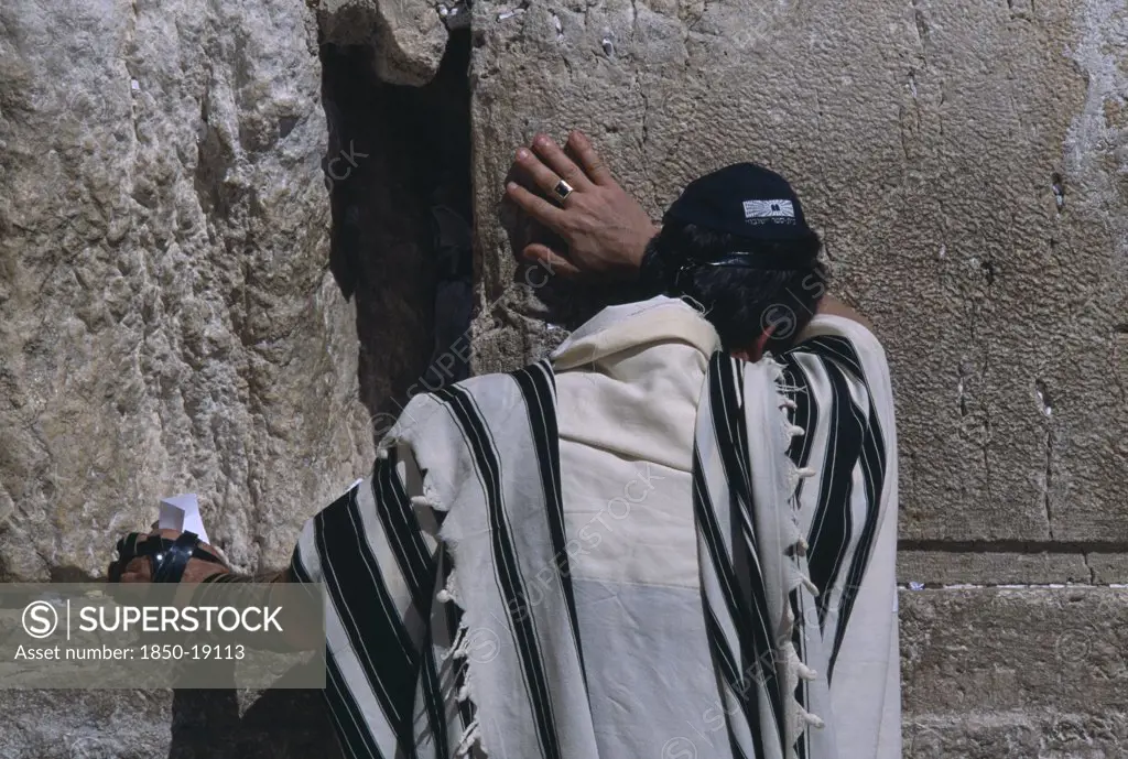 Israel, Jerusalem, A Jewish Man Wearing A Traditional Prayer Shawl Praying At The Western Wall