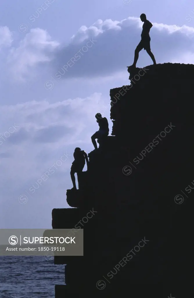 Israel, Acre, Arab Boys Climbing The Old Harbour Walls To Jump Into The Sea