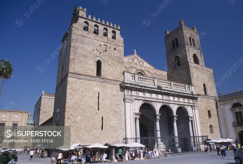 Italy, Sicily, Palermo, Monreale. Ii Duomo Norman Cathedral Exterior With People Gathered Around Small Market Stalls Next To The Walls