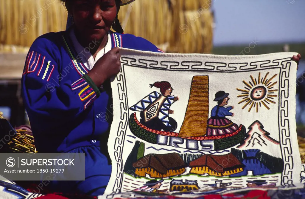 Peru, Puno Administrative Department, Lake Titicaca, 'Uros Floating Islands/Aymara Woman. The Aymara Women Who Inhabit The Floating Reed Islands Of Uros On Lake Titicaca, Make A Living From Tourism: Selling Hand Made Trinkets And Patterned Wall Hangings'