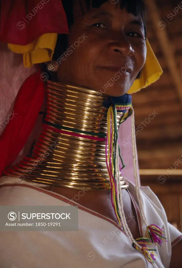 Thailand, Chiang Rai Province, Mae Chan, Head And Shoulders Portrait Of Paduang Long Neck Woman With Neck Elongated By Lengths Of Coiled Brass.