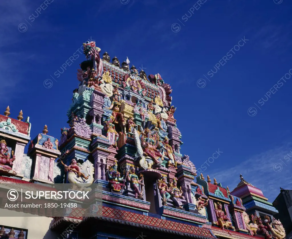Malaysia, Penang, Georgetown, Sri Mariamman Temple.  Angled Part View Of Exterior And Gopuram Painted Tower Decorated With Brightly Painted Figures Of Hindu Gods And Characters.