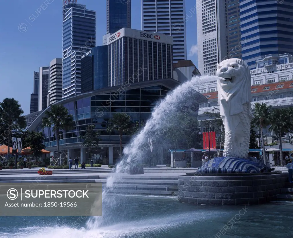 Singapore, Merlion Park, Merlion Statue And Fountain In Front Of The Fullerton Hotel And City Buildings Including Hsbc Bank And Tung Centre.
