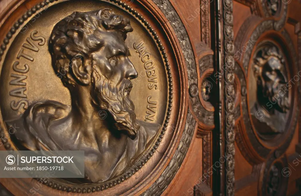 Hungary, Budapest, Basilica Of St Stephen.  Detail Of Door With Bronze Relief Carvings Of The Heads Of The Twelve Apostles. Eastern Europe