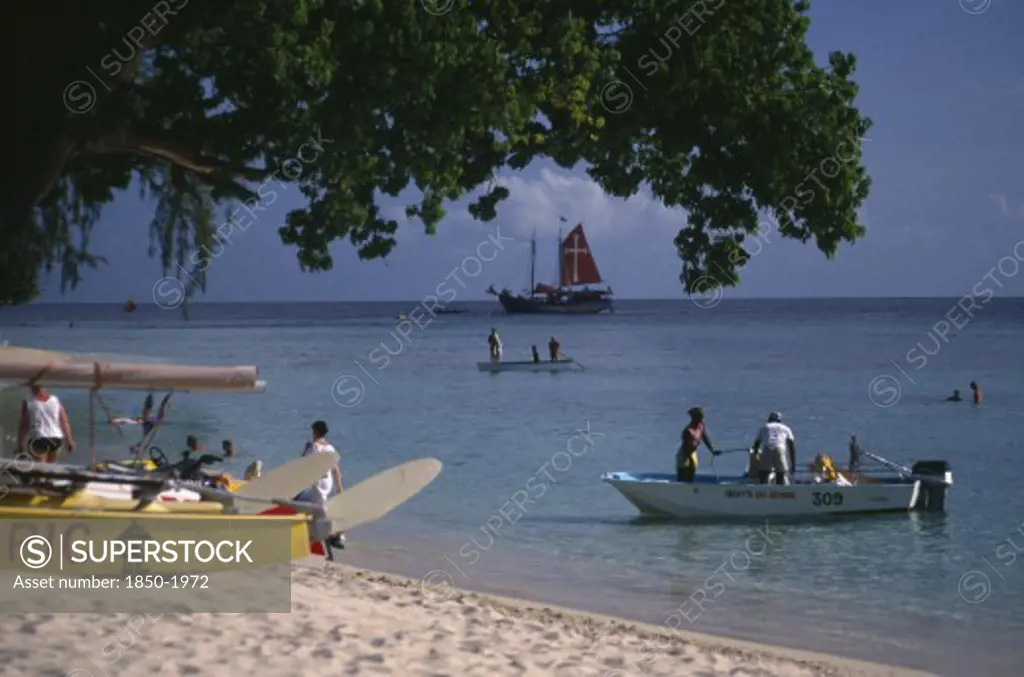 West Indies, Barbados, St James, Holetown. Various Boats And Tourist Water Activities Beside Beach.