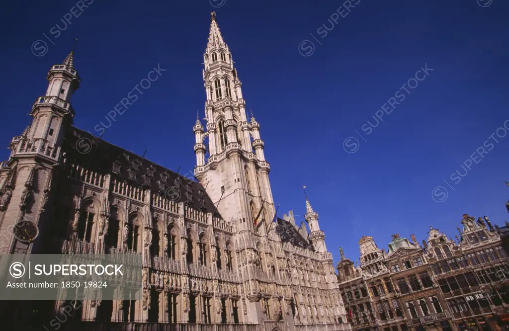 Belgium, Brabant, Brussels, The Grand Place.  Hotel De Ville.  Angled View Of Exterior Facade Decorated With Statues Representing The Dukes And Duchessess Of Brabant.