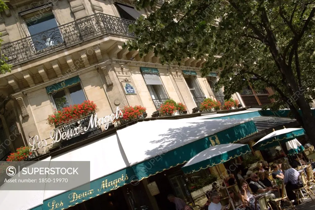 France, Ile De France, Paris, People At Pavement Tables Outside Les Deux Magots The Famous Literary Cafe Frequented By The Surrealists On Place St Germain Des Pres