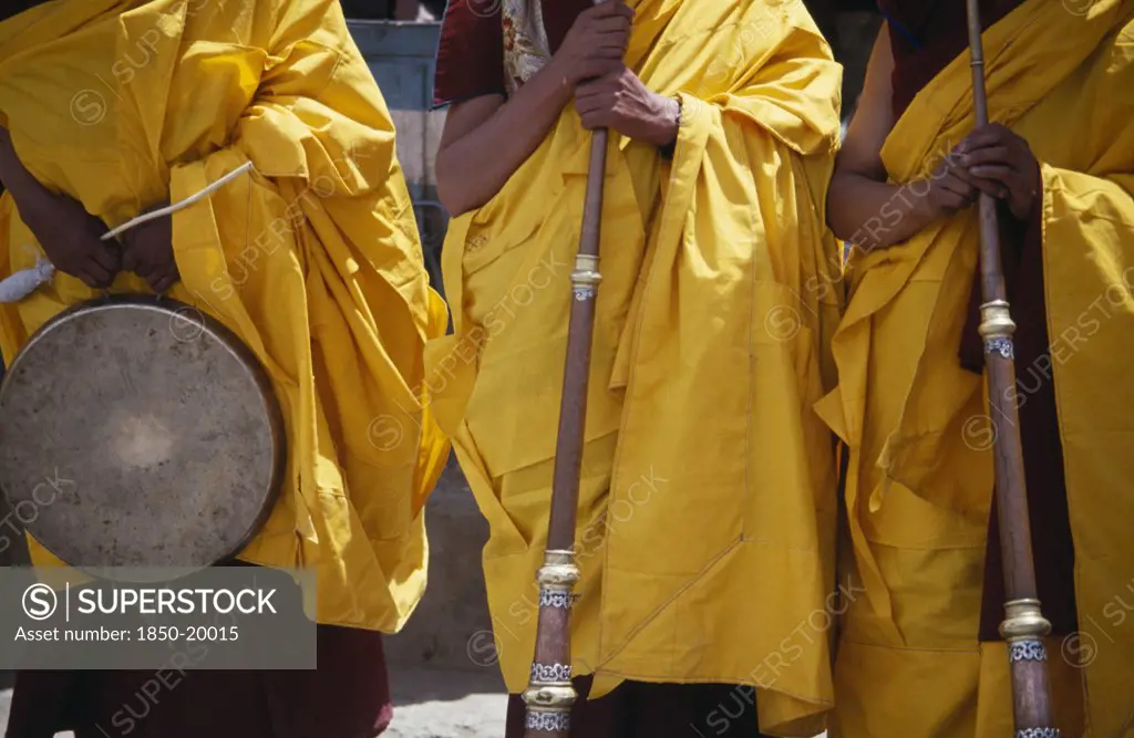 India, Ladakh, Hemis Gompa, Tibetan Buddhist Lamas In Ceremonial Yellow Dress With Traditional Instruments Attending Annual Hemis Festival To Celebrate Birth Of The Founder Of Tibetan Buddhism.