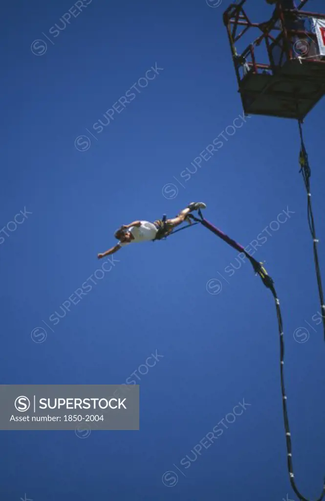 Sport,  , Bungee Jumping, Man Diving From A Crane With Elastic Cord Tied To His Ankles