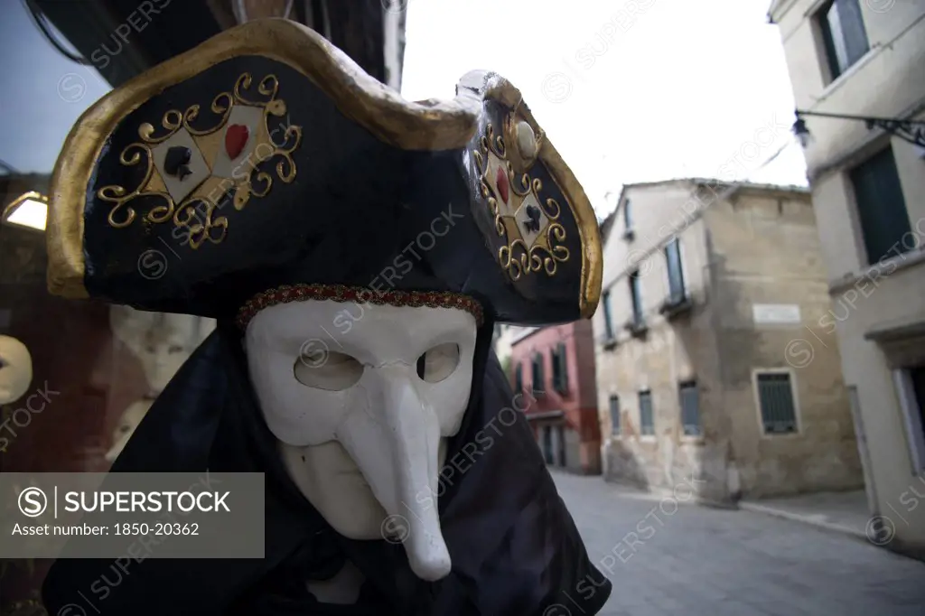 Italy, Veneto, Venice, Masked Carnival Figure Outside A Shop In The San Polo District
