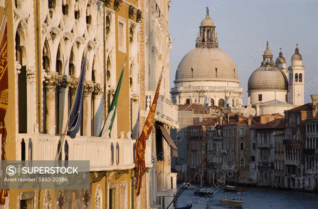 Italy, Veneto, Venice, The Baroque Church Of Santa Maria Della Salute On The Grand Canal. The Palazzo Franchetti Cavalli Of Archduke Frederick Of Austria On The Left Is Decked With Flags