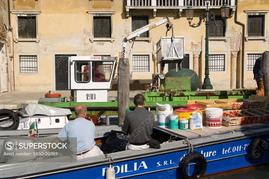 Italy, Veneto, Venice, Painters And Decorators Wait To Moor Their Boat On The Grand Canal Whilst A Refuse Collection Boat Collects Garbage