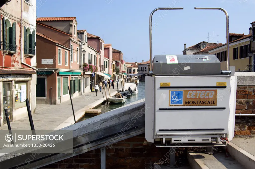 Italy, Veneto, Venice, A Mechanically Operated Wheelchair Ramp On A Bridge Across The Rio Dei Vetrai Canal On The Lagoon Island Of Murano