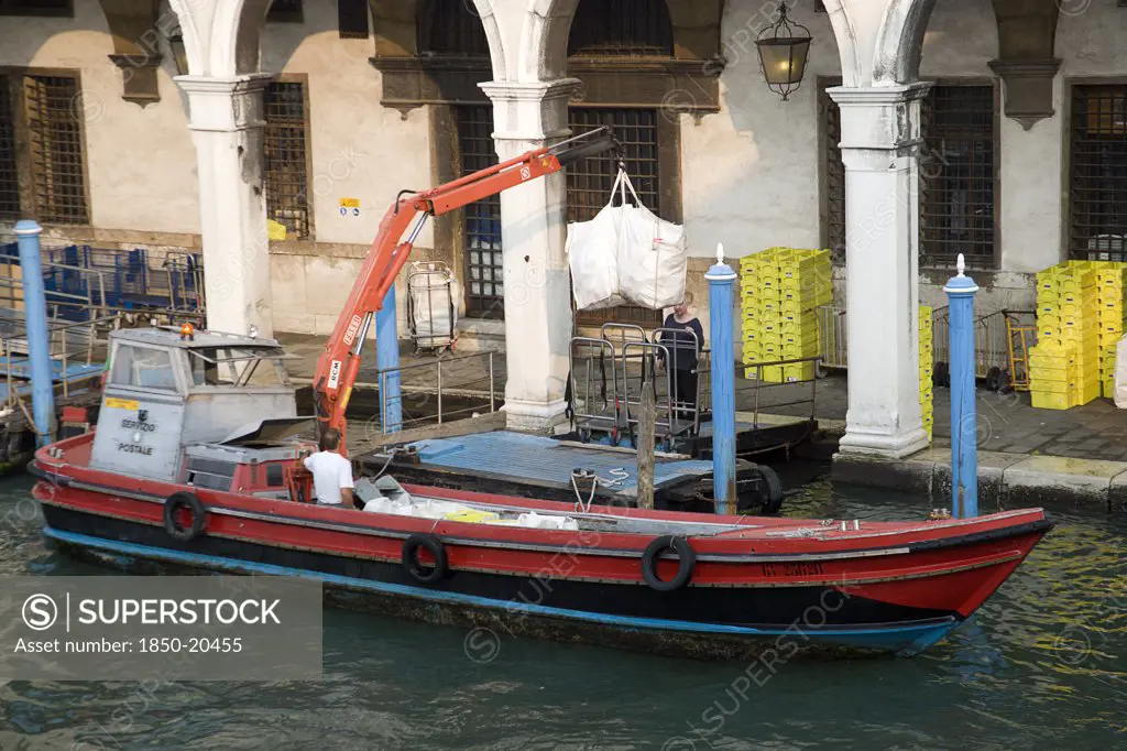 Italy, Veneto, Venice, A Postal Service Barge Collecting Mail From The Main Post Office On The Grand Canal Beside The Rialto Bridge
