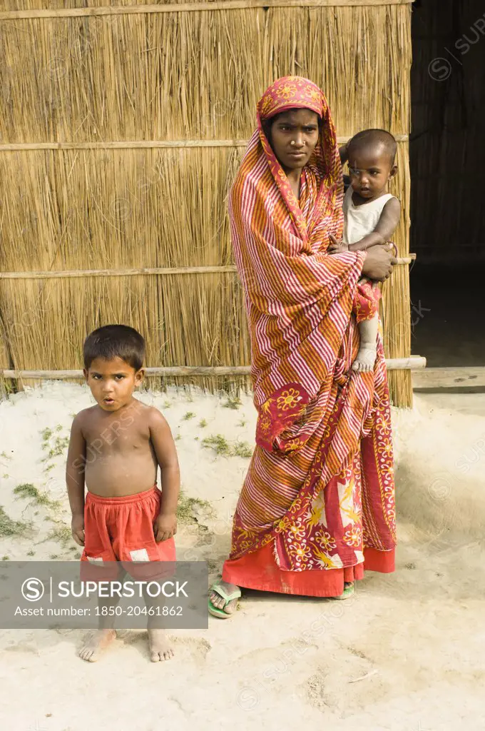 Bangladesh, Dhaka Division, Tangail Sadar Upazila, Mother and children on the impoverished chars, beside the Brahmaputra river.