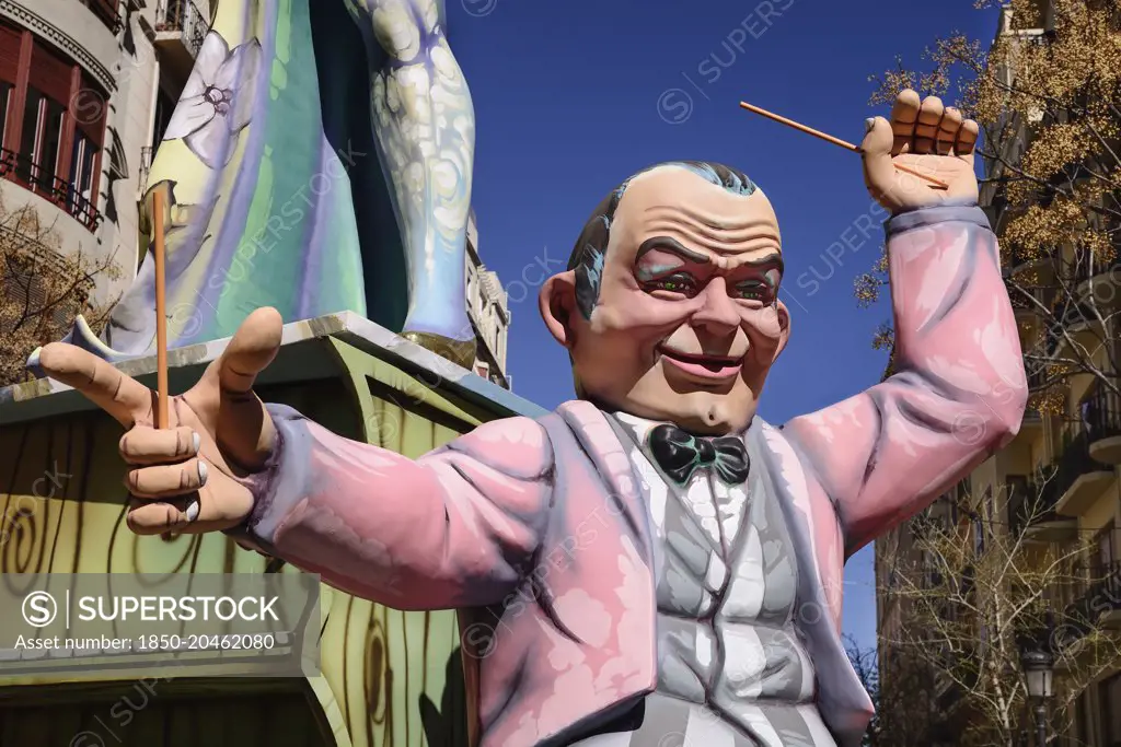 Spain, Valencia Province, Valencia, Papier Mache figure of a man in a pink jacket in the street during Las Fallas festival.