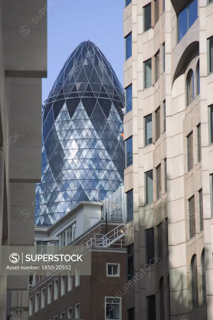 England, London, 'Detail Of The Top Of The Gherkin Swiss Re Building, 30 St Mary Axe, Seen Through Narrow City Street. Designed By Architect Sir Norman Foster.'