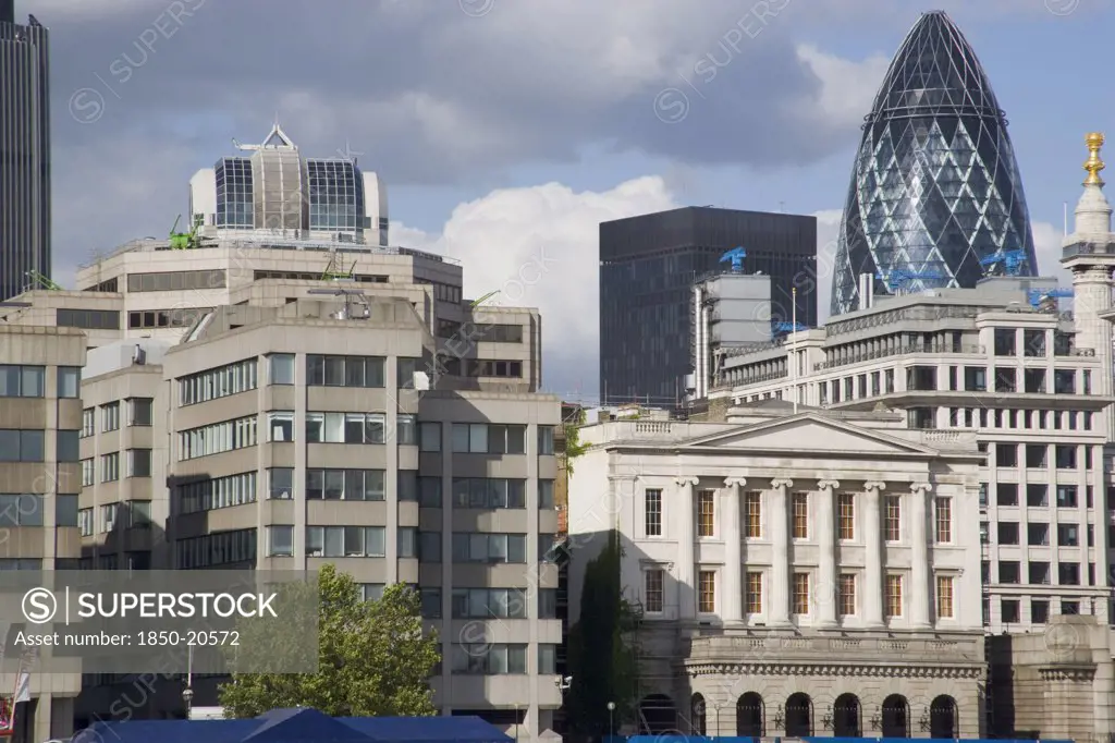England, London, 'The Gherkin Swiss Re Building Seen, Through Tightly Huddled Buildings In The City, From London Bridge.'