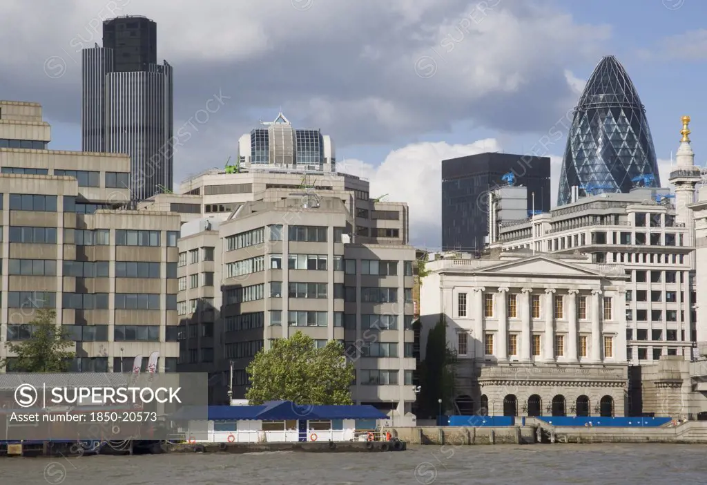England, London, 'The Gherkin Swiss Re Building Seen, Through Tightly Huddled Buildings In The City, From London Bridge.'