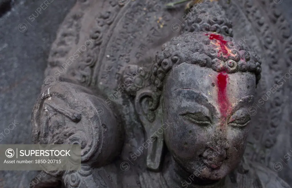 Nepal, Kathmandu, Detail Of Buddha Statue Anointed With Pink Powder.