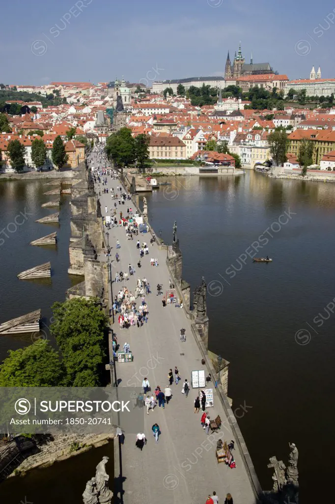 Czech Republic, Bohemia, Prague, People Walking Across The Charles Bridge Across The Vltava River Towards The Little Quarter